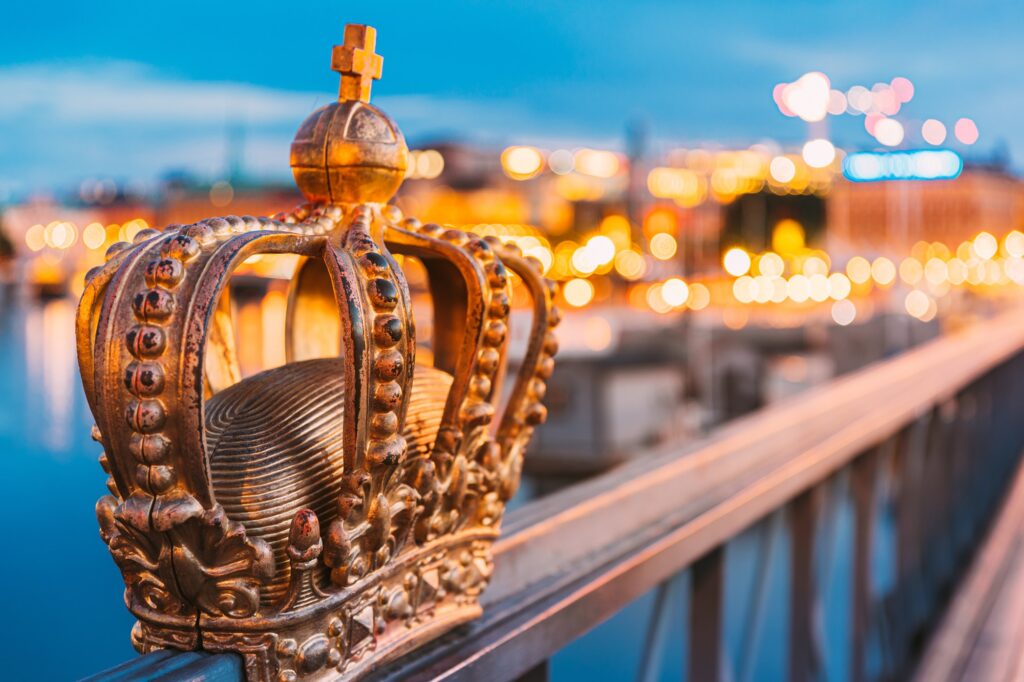 Stockholm, Sweden. Skeppsholmsbron - Skeppsholm Bridge With Its Famous Golden Crown In Night Lights